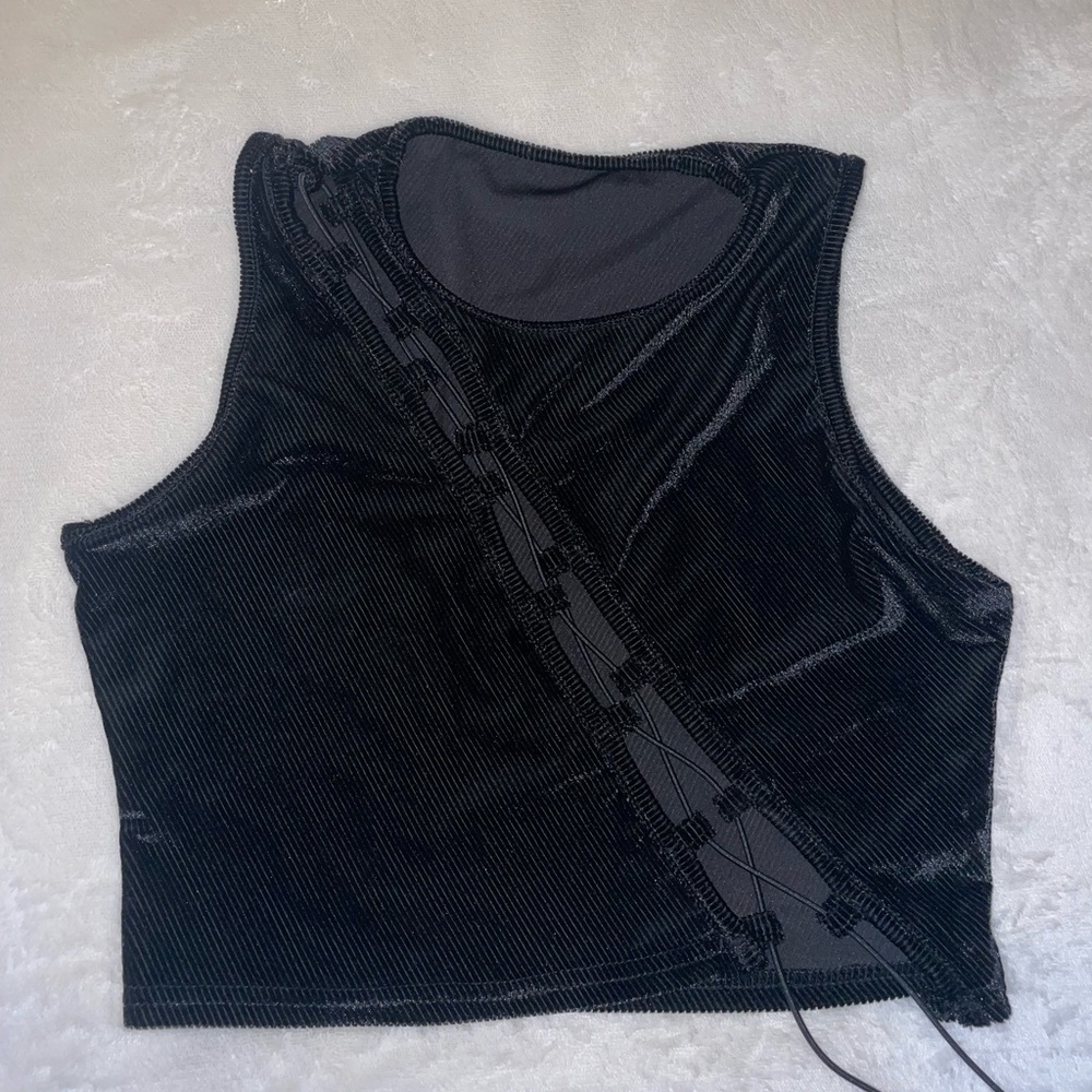 Black crop top, never worn, with opening diagonal across chest